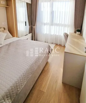 Modern bedroom with a double bed, wardrobe, and desk. - image 10