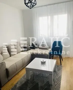 Living room with a sectional sofa, coffee table, and window. - image 10