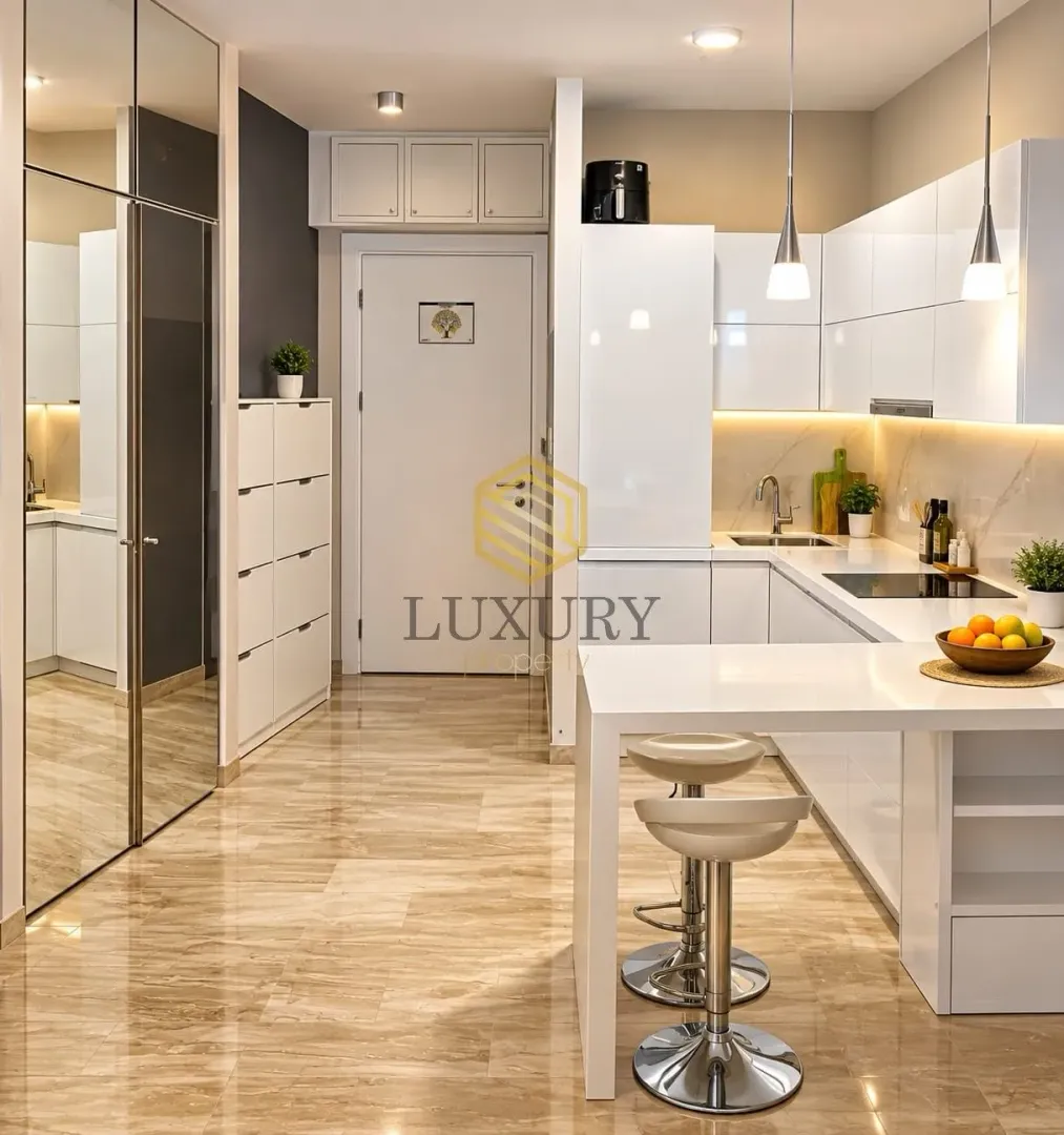 Modern white kitchen with a breakfast bar and dining table.