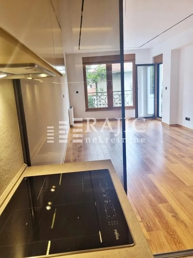 View from the kitchen towards the living room with wooden flooring.