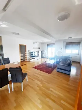 Spacious living room with dining area and parquet flooring. - image 13