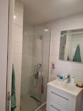 Bright modern bathroom with a shower cabin and a washbasin. - image 3