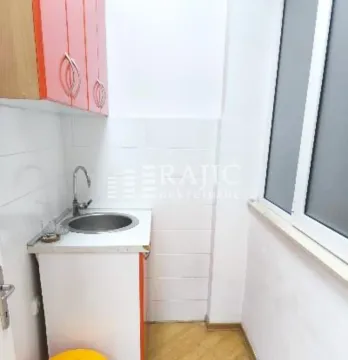 Small kitchen with a sink, cabinets, and a window. - image 5