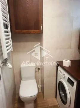 Manje kupatilo sa wc šoljom, mašinom za veš i zidnim ormarićem. - image 19