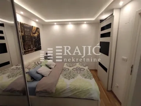Furnished bedroom with a double bed and built-in wardrobes. - image 11