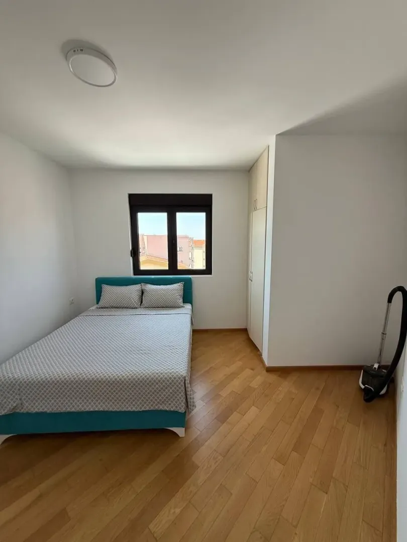 Smaller bedroom with a double bed, wardrobe, and window.