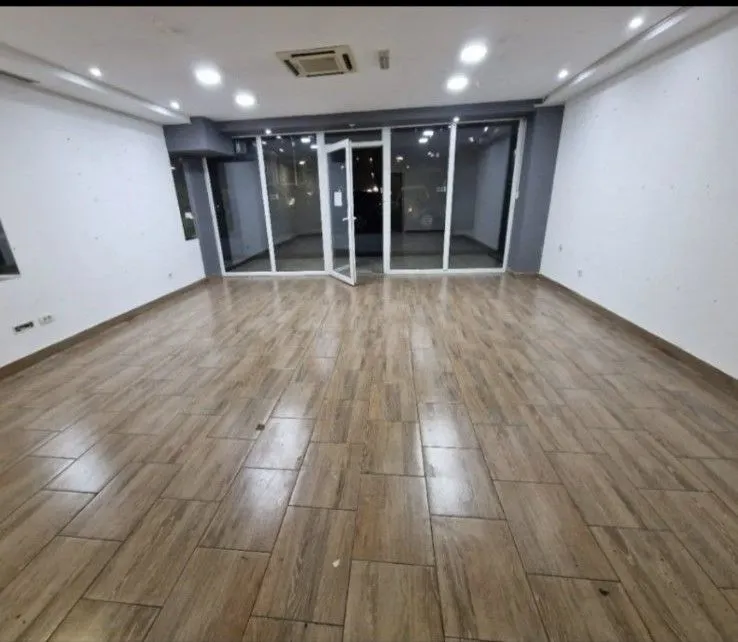 Empty commercial space with a glass storefront.