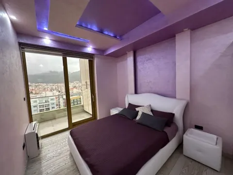 Modern bedroom with a double bed, purple walls, and balcony access. - image 5