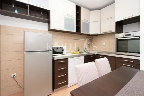 Kitchen equipped with household appliances and a dining table. - image 2