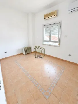 Empty bright room with tiled flooring, a window, and an air conditioning unit. - image 3