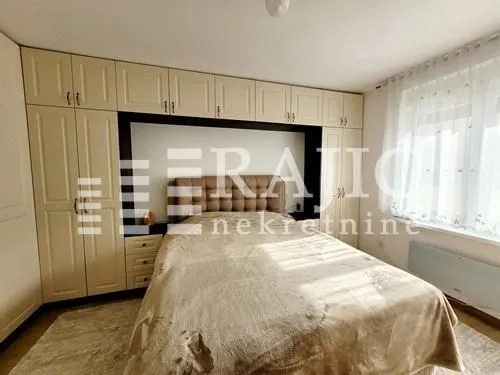 Furnished bedroom with built-in closets and a double bed.