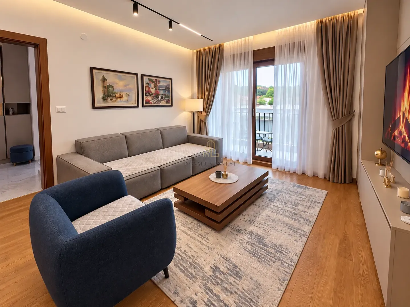 Modern living room with a sofa, wooden coffee table, and access to the terrace.