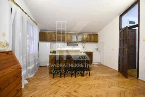 Kitchen with wooden cabinetry, a breakfast bar, and parquet flooring. - image 5
