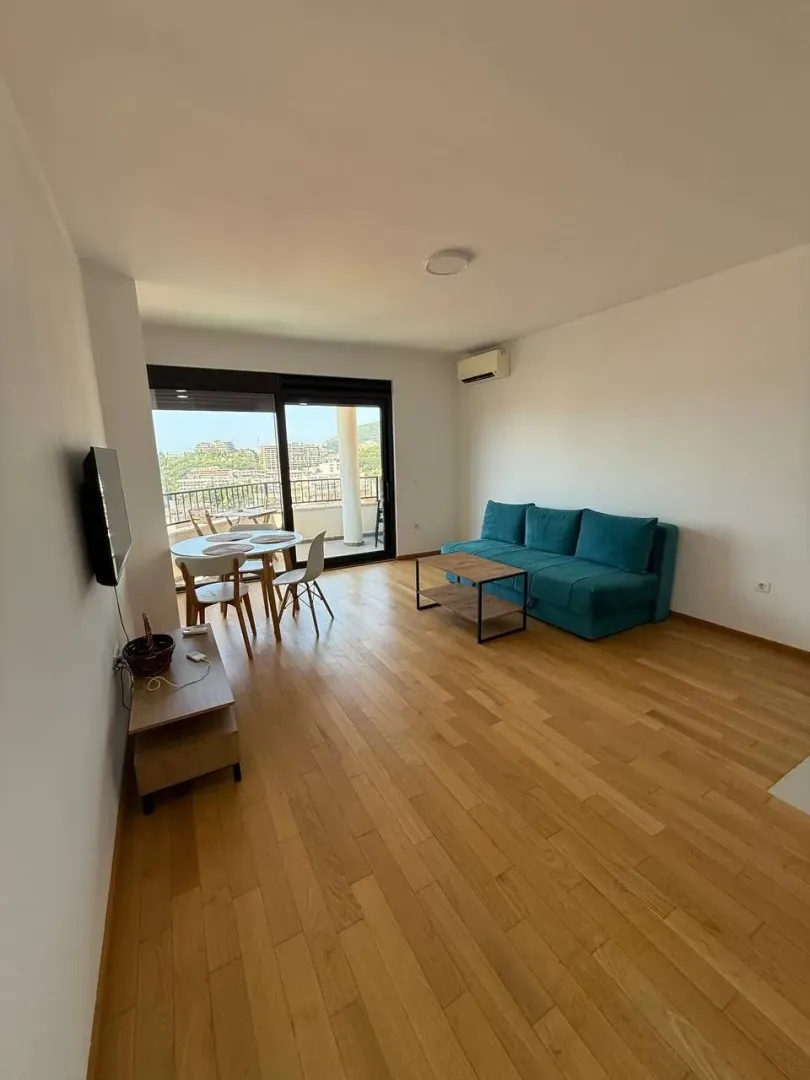 Spacious living room with a sofa and dining area.