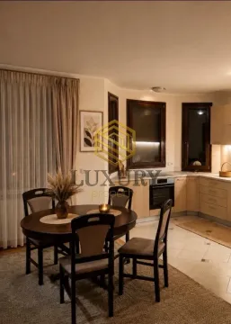 Dining area with a table and chairs connected to the kitchen. - image 2