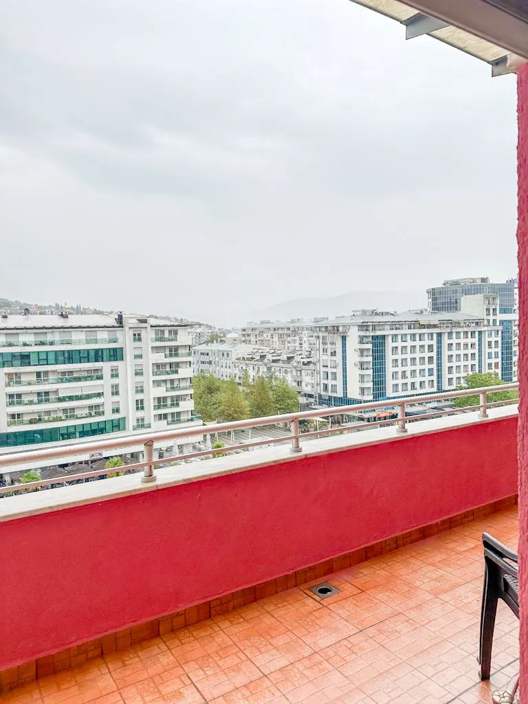 Spacious balcony with a city view.
