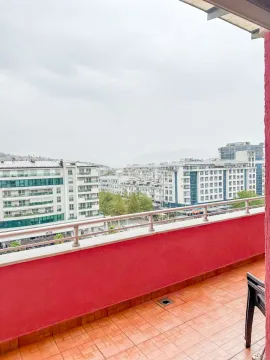 Spacious balcony with a city view. - image 11