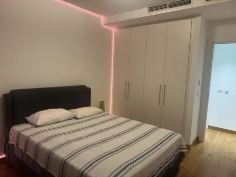 Modern bedroom with a double bed and a fitted wardrobe. - image 10