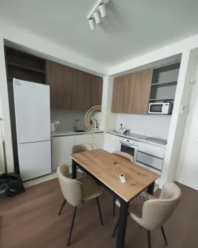 Kitchen with a dining table and chairs. - image 7