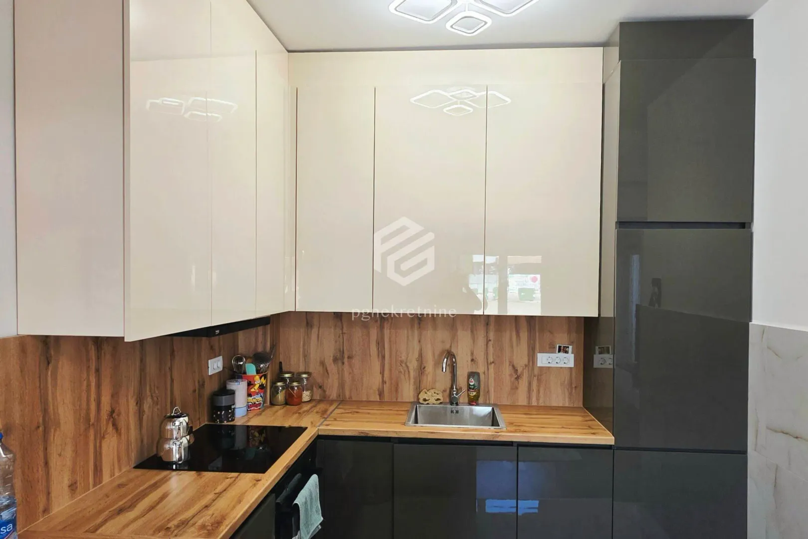 Modern kitchen with built-in cabinetry and a wooden countertop.