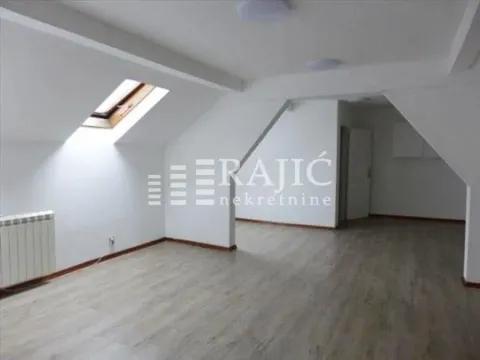 Empty attic room with laminate flooring and a skylight. - image 3
