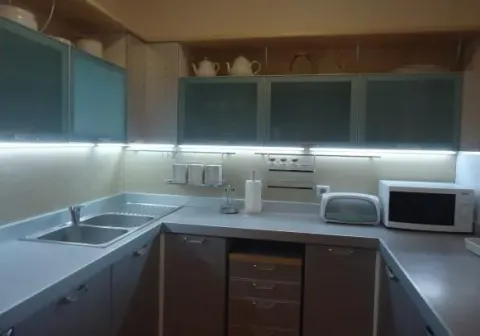 Functional kitchen with grey cabinets and LED lighting. - image 4
