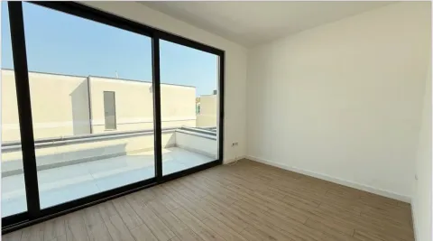 Empty room with large glass doors and a view of the terrace. - image 8