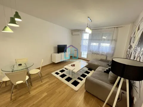 Living room with a sofa, dining table, and access to the terrace. - image 3