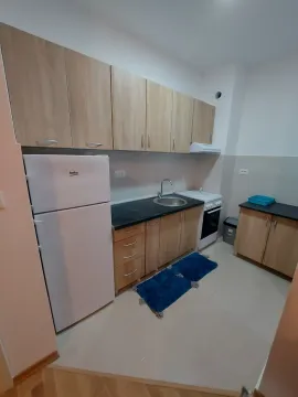 Small kitchen with light wood cabinets. - image 3