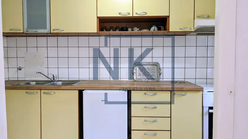 Kitchen with light cabinets, a sink, and a countertop.