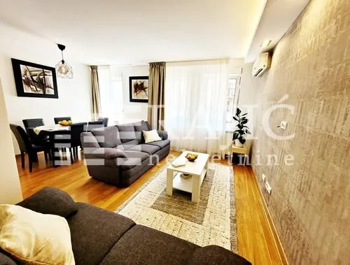 Spacious living room connected to the dining area with modern furniture.