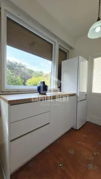 Small kitchen with white units and a refrigerator. - image 3