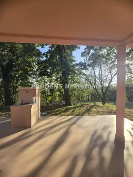 Covered terrace overlooking the yard and greenery. - image 10
