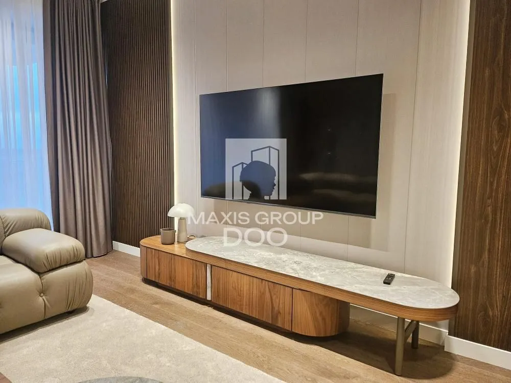 Living room featuring a television wall and wooden media console.