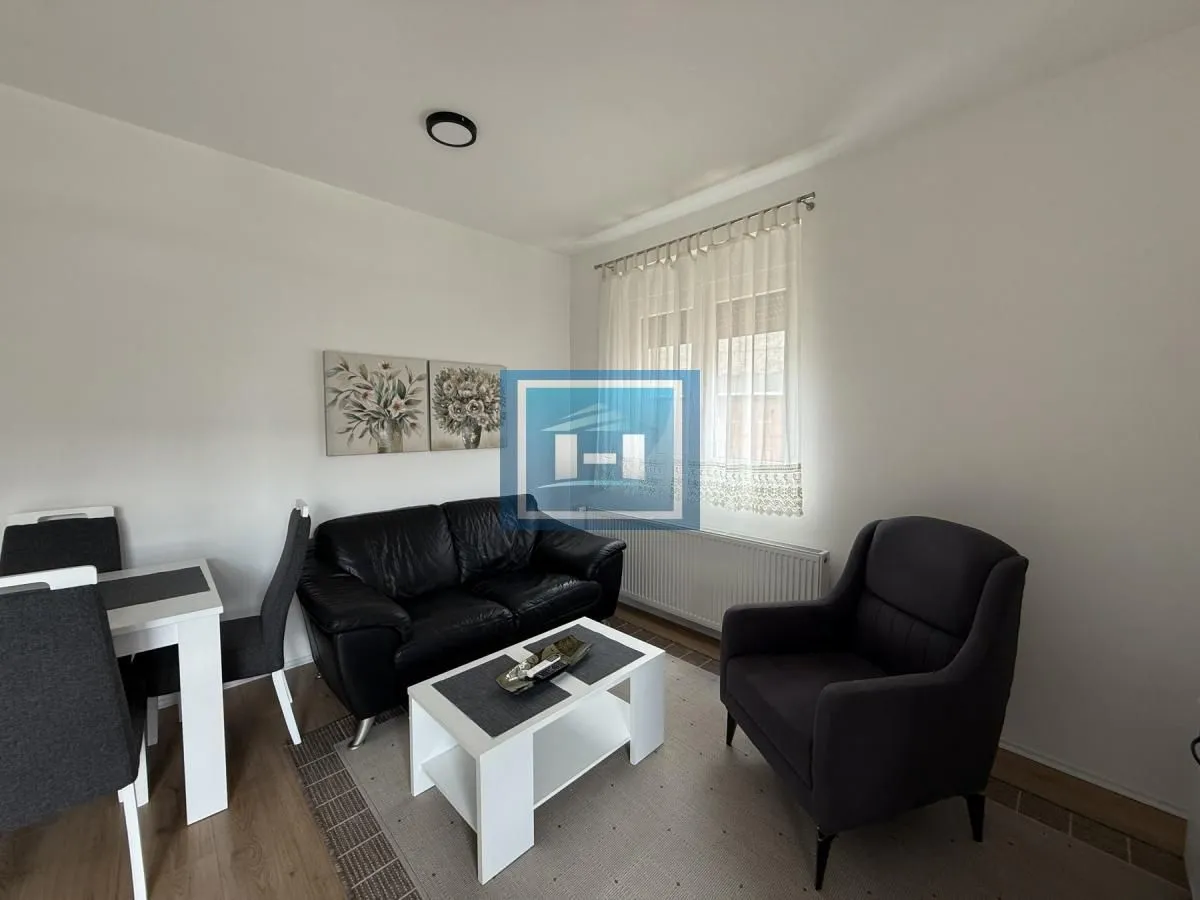 Living room with seating furniture and a dining table.