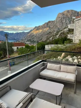Furnished terrace with seating furniture and a view of the mountains and settlement. - image 2