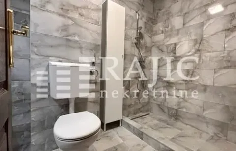 Modernly equipped bathroom with a walk-in shower and grey ceramic tiles. - image 13
