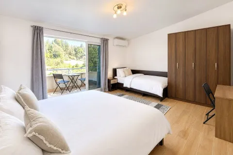 Spacious bedroom with a double bed, wardrobe, and access to the terrace. - image 16