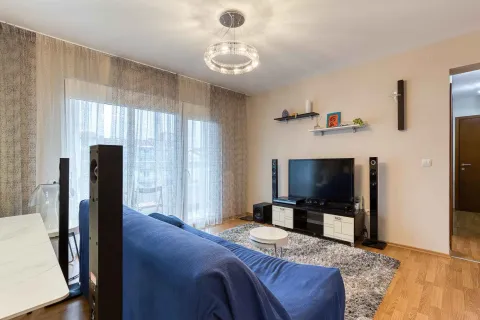 Living room with a blue sofa, TV, and access to the terrace. - image 3