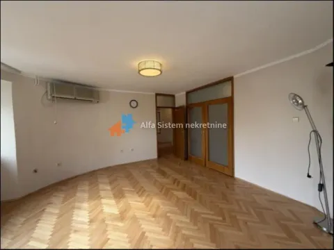Empty living room with parquet flooring and an air conditioner. - image 4