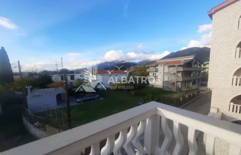 View from the terrace of the surrounding buildings, courtyard, and distant mountains. - image 14