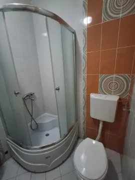 Bathroom with a shower cabin and a toilet. - image 10