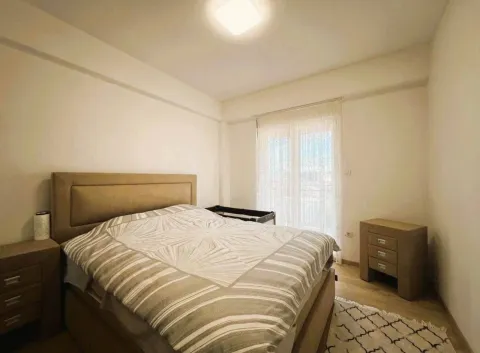Furnished bedroom with a double bed and balcony access. - image 6
