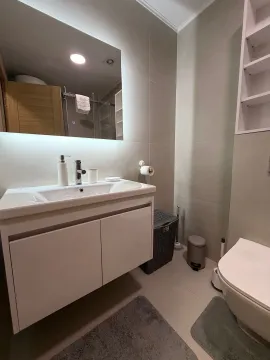 Modernly equipped bathroom with a washbasin and a mirror. - image 13