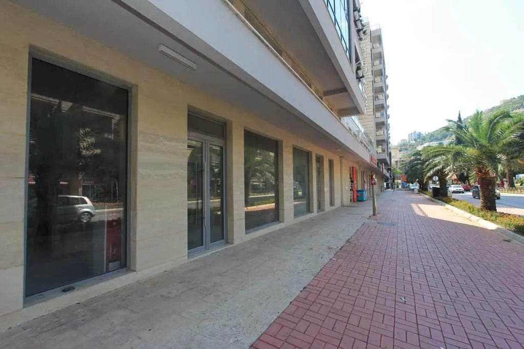 Exterior view of a ground-floor commercial space with large glass storefronts.