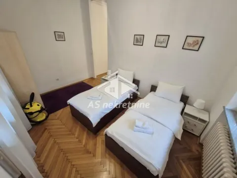 Bedroom with two single beds and parquet flooring. - image 16