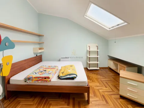 Children's bedroom with a wooden bed and a skylight. - image 16