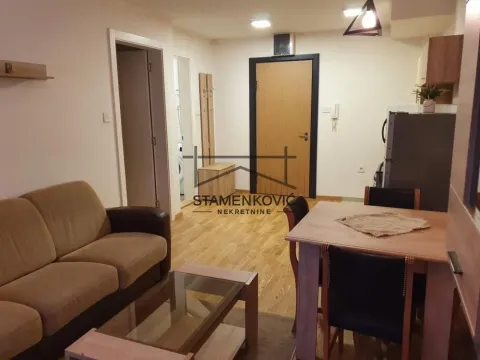 Living room with a sofa set, dining table, and kitchen in the background. - image 7