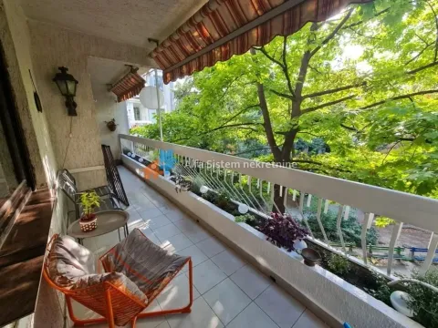 Spacious balcony with seating furniture and a green view. - image 22