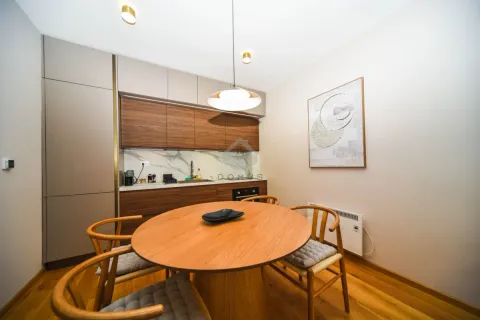Modern kitchen with wooden elements and a dining table. - image 5